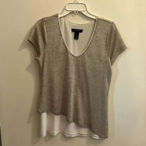 Cute top! Little bit of sheen and super cute unique hem line.